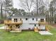 A view of the back of this home featuring a wooden deck and a grassy backyard at 109 Chatterson Dr, Raleigh, NC 27615