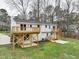 A view of the back of this home featuring a wooden deck and a grassy backyard at 109 Chatterson Dr, Raleigh, NC 27615