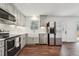 Updated kitchen boasts stainless steel appliances, grey cabinets and exterior access at 109 Chatterson Dr, Raleigh, NC 27615