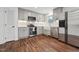 Well-lit kitchen showcases grey cabinetry, stainless appliances, and wood flooring at 109 Chatterson Dr, Raleigh, NC 27615