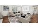 Bright living room with neutral furniture, a large window, and hardwood floors at 109 Chatterson Dr, Raleigh, NC 27615