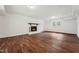 The unfurnished living room has a fireplace, wood floors, and a bright window at 109 Chatterson Dr, Raleigh, NC 27615