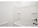 A bathroom with white walls and a tub shower combination with shelves at 1205 Porters Call Dr, Wendell, NC 27591