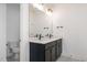 Modern bathroom featuring double vanity with black hardware and gray cabinets at 1205 Porters Call Dr, Wendell, NC 27591
