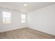 Bright bedroom with hard wood floors and two windows for natural light at 1205 Porters Call Dr, Wendell, NC 27591