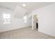 A bedroom with neutral carpet, three windows, white walls, and a door to a bathroom at 1205 Porters Call Dr, Wendell, NC 27591
