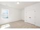 Bedroom featuring neutral carpet, a large window, and a closet at 1205 Porters Call Dr, Wendell, NC 27591