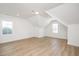 A bedroom with light wood floors, white walls, and dormer windows at 1205 Porters Call Dr, Wendell, NC 27591