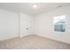 An empty bedroom with neutral carpet, a double door closet, one window, and white walls at 1205 Porters Call Dr, Wendell, NC 27591