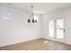 Bright dining area features a modern chandelier and glass doors to the outside at 1205 Porters Call Dr, Wendell, NC 27591