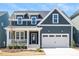 Charming home with a covered porch, two-car garage, and a well-manicured lawn at 1205 Porters Call Dr, Wendell, NC 27591