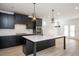 Well-designed kitchen with black cabinets, an island, and stainless steel appliances at 1205 Porters Call Dr, Wendell, NC 27591