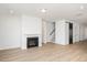 Bright living room features a fireplace, staircase, and sliding barn door at 1205 Porters Call Dr, Wendell, NC 27591