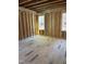 Interior view of a room under construction with exposed wood framing and two windows at 1224 Red Cedar Ct # 33, Youngsville, NC 27596