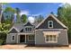Charming home with gray siding, gabled roof, and stone accents, presenting a welcoming curb appeal at 1224 Red Cedar Ct # 33, Youngsville, NC 27596
