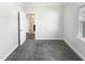 A well-lit bedroom features neutral walls, plush gray carpeting, and a doorway leading to an en-suite bathroom at 154 Magenta Rose Dr, Raleigh, NC 27610