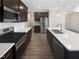 Gourmet kitchen featuring a large island with a sink, stainless steel appliances, and dark wood cabinets at 154 Magenta Rose Dr, Raleigh, NC 27610
