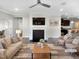 Bright living room boasts a fireplace and seamlessly connects to the kitchen and dining areas at 154 Magenta Rose Dr, Raleigh, NC 27610