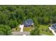 Stunning aerial view of a beautifully landscaped property surrounded by lush green trees and a winding driveway at 175 Stonecrest Way, Pittsboro, NC 27312