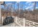 Back deck with white railings overlooking wooded yard with trees and foliage at 175 Stonecrest Way, Pittsboro, NC 27312