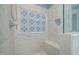Custom tiled shower with decorative pattern and built-in bench at 175 Stonecrest Way, Pittsboro, NC 27312