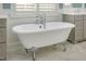 Classic white bathtub with chrome fixtures and a window creating a light and airy bathroom at 175 Stonecrest Way, Pittsboro, NC 27312