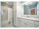 Well-lit bathroom with a combined tub and shower, white cabinets, and marble patterned flooring at 175 Stonecrest Way, Pittsboro, NC 27312