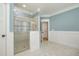 Modern bathroom features a glass shower with decorative tile, and a light blue painted wall at 175 Stonecrest Way, Pittsboro, NC 27312