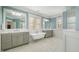 Luxurious bathroom featuring double vanities, a freestanding tub, and elegant tile flooring at 175 Stonecrest Way, Pittsboro, NC 27312