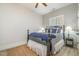 Bright bedroom with wood-look floors, elegant black bedframe and vintage nightstands at 175 Stonecrest Way, Pittsboro, NC 27312
