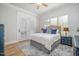 Well-lit bedroom with neutral walls, shuttered windows, french doors, and blue and white decor at 175 Stonecrest Way, Pittsboro, NC 27312