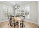Bright dining area with large windows and stylish chandelier at 175 Stonecrest Way, Pittsboro, NC 27312