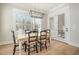 Bright dining room features a chandelier, natural light from the window, and french doors to the outside at 175 Stonecrest Way, Pittsboro, NC 27312