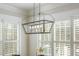 Dining room with a modern chandelier and window with plantation shutters at 175 Stonecrest Way, Pittsboro, NC 27312