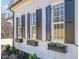 Exterior view of a home with flower boxes under the windows and black shutters at 175 Stonecrest Way, Pittsboro, NC 27312