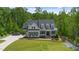 A beautiful home with a manicured lawn, a car in the driveway and beautiful landscaping at 175 Stonecrest Way, Pittsboro, NC 27312