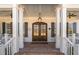 Inviting entryway featuring white columns, a double door, and a brick landing at 175 Stonecrest Way, Pittsboro, NC 27312