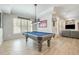 Recreation room featuring a pool table, plank flooring, bright windows and decorative wall art at 175 Stonecrest Way, Pittsboro, NC 27312