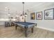 Spacious game room with a pool table, bar seating, and views of the kitchen at 175 Stonecrest Way, Pittsboro, NC 27312