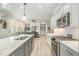 Open concept kitchen with stainless steel appliances, island with sink, and view into the living room at 175 Stonecrest Way, Pittsboro, NC 27312