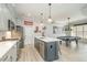Modern kitchen with an island, stainless steel appliances, and open to a recreation room with a pool table at 175 Stonecrest Way, Pittsboro, NC 27312
