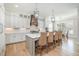 Modern kitchen featuring a large island with bar seating, stylish pendants, and white cabinetry at 175 Stonecrest Way, Pittsboro, NC 27312