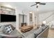 Comfortable living room featuring a brick fireplace, large leather sofa, and a ceiling fan with lighting at 175 Stonecrest Way, Pittsboro, NC 27312