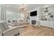 Bright living room with built-in shelving, fireplace, and comfortable seating arrangement at 175 Stonecrest Way, Pittsboro, NC 27312