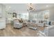 Open-concept living room with modern furnishings and an adjoining kitchen at 175 Stonecrest Way, Pittsboro, NC 27312