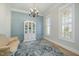 Bright living room features natural light, hardwood floors, and an elegant chandelier at 175 Stonecrest Way, Pittsboro, NC 27312