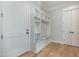 Mudroom features a white storage bench and wood floors at 175 Stonecrest Way, Pittsboro, NC 27312