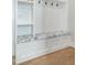 Mudroom features a white storage bench with blue patterned cushions and hardwood floors at 175 Stonecrest Way, Pittsboro, NC 27312