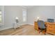 Bright office with light wood flooring and white trim, featuring a wooden desk and a window with plantation shutters at 175 Stonecrest Way, Pittsboro, NC 27312