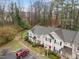 Aerial view featuring a townhome community with parking and sidewalks, nestled among tall trees and lush greenery at 2268 Plum Frost Dr, Raleigh, NC 27603